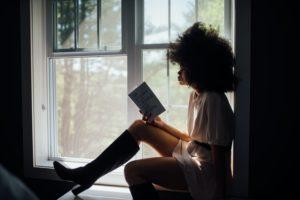 Woman reading book alone