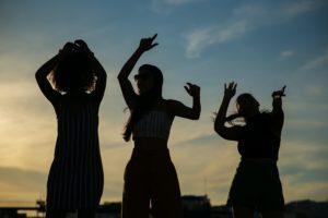 group of friends celebrating sunset