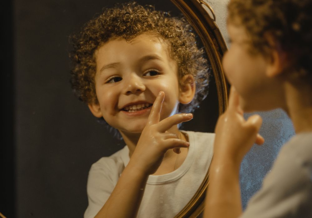 Boy looking on the mirror