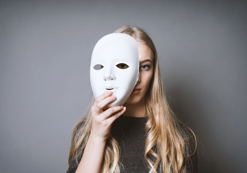 Girl holding a mask on her face